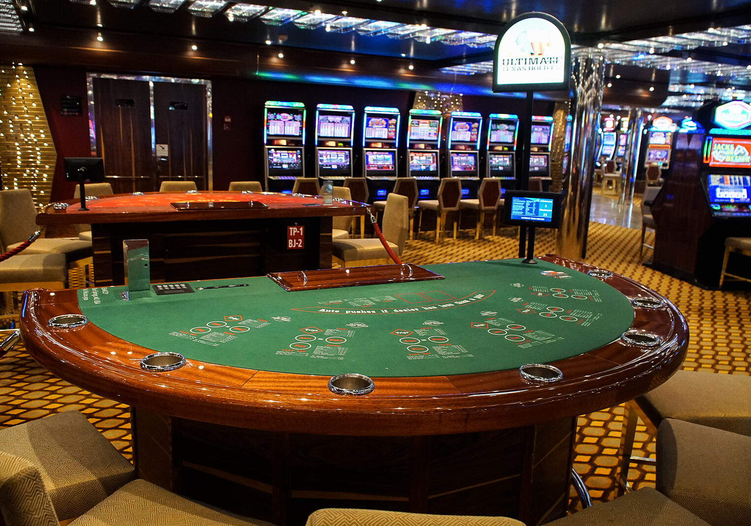 Barcelona, Spain, July 11, 2016 : Casino interior room with blackjack Table and slot machines on a cruise boat. Gambling entertainment concept.